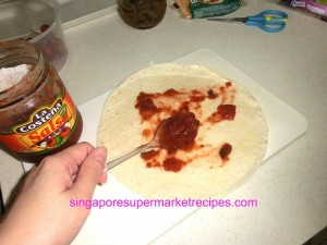 chicken quesadilla spreading salsa